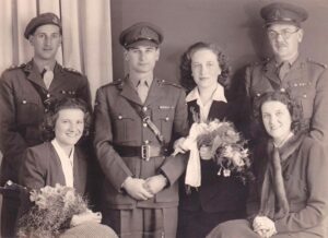 Wedding photograph with Judith's girlfriends from the Interpreters' service, Harold's colonel and his army friends